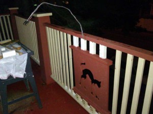 CNC Cutout of screeching cat inserted into porch railing